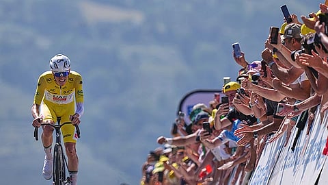 WATCH THE CHAMP. Cycling star Tadej Pogačar, clad in the yellow jersey as the overall leader, powers past cheering fans during Stage 13 of the 2025 Tour de France. / Photo from the Wires