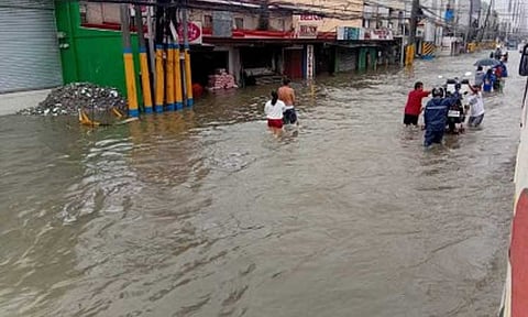WATERWORLD. A portion of Aguinaldo Highway in Bacoor City, Cavite is under knee-deep flood following a heavy downpour on Tuesday (July 22, 2025). The widespread flooding in the city has prompted the local government to declare a state of calamity, which will allow the utilization of calamity fund to augment and address the needs of affected communities. (PNA photo by Jelly Musico)