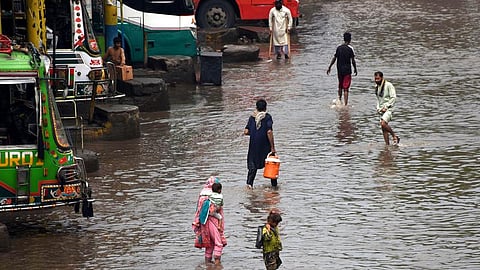 People wade through floodwater in a street after heavy monsoon rain in Lahore, Pakistan on July 9, 2025. (Photo by Sajjad/Xinhua)