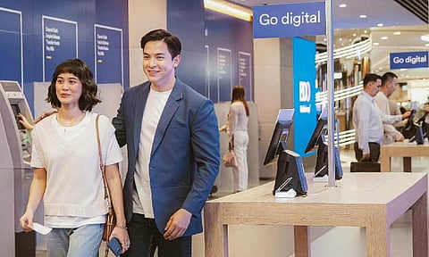 ROUND THE FAVORITE PARTNER. Alden Richards makes the round of branch innovations with a client to help her explore a wide range of products and services at his favorite bank partner, BDO. (Photo courtesy of BDO)