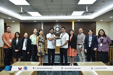 PCC Executive Director Kenneth Tanate (5th from right), Mergers and Acquisitions Office Directors Lianne Ivy Medina and Michael Kris Ben Herrera (4th & 3rd from right), and other PCC staff with Grab Holdings, Inc. and MyTaxi.PH, Inc. representative Atty. Erasto Miguel Aguila (center) during the signing of Grab's 2025 Extended Undertaking with the PCC, held on September 16, 2025, in Quezon City.