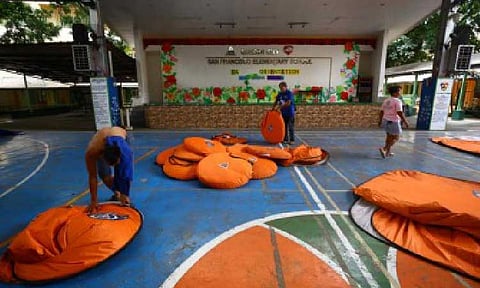 ALL CLEAR. Maintenance staff dismantle modular tents used by evacuees at the San Francisco Elementary School in Quezon City on Sept. 27, 2025. Families affected by the combined effects of the southwest monsoon (habagat), tropical cyclones Mirasol, Nando and Opong has reached 906,794, which is equivalent to 3,402,391 persons, the National Disaster Risk Reduction and Management Council said Monday (Sept. 29). (PNA photo by Joan Bondoc)