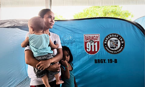 A family participates in the third river-wide flood drill on Saturday, September 27, 2025, organized by the Barangay 19-B Disaster Risk Reduction and Management Office (BDRRMO), at a covered court near the riverbank of El Rio Vista Village in Bacaca, Davao City. The Davao City Government, through the Davao City Disaster Risk Reduction and Management Office (CDRRMO), conducted its flood simulation exercise in barangays along the Davao River. Barangay officials and residents participated in the drill and familiarized themselves with the designated evacuation areas. The drill also comes after a number of individuals were found dead after being swept away at the Mini Asik-Asik Falls in Calinan.