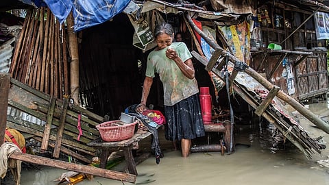 VERBENA’s WAKE. A resident in Barangay San Rafael, Barili in southern Cebu wades through the flood remnants, trying to recover belongings and clear debris from her home after the Santa Ana River overflowed during Tropical Depression Verbena on Tuesday, Nov. 25, 2025. /