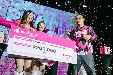 A Bacolod Ka-panda rider beams after winning the grand prize during the fun-filled Pera o Panda Bag game at the Visayas leg of foodpanda Logistics' annual Pau-tastic Party ng Taon.