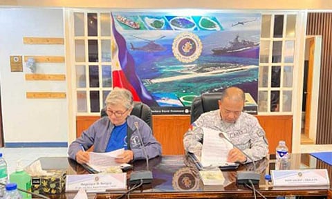 STRONGER TIES. Western Naval Command chief Rear Adm. Vincent Sibala and Angelique Songco, area superintendent of Tubbataha Reefs Natural Park, sign a memorandum of understanding (MoU) for the co-location of Naval Monitoring Detachment (NMD) Tubbataha at Tubbataha Reefs Natural Park Ranger Station on Feb. 3, 2026. The new facility is expected to provide real-time naval support for patrols, surveillance, and rapid response. (Photo courtesy of the WNC)