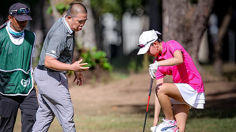 Tash Balangauan brushes off ants after an unfortunate landing in an insect-infested patch on the rough of No. 4.