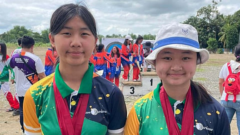 ON TARGET TOGETHER Davao Region cousins Daphne Manuelle M. Uyking (left) and Jasmin Jane U. Lim display their medals after the Davao Regional Athletic Association meet, using their shared journey and discipline to prepare for the archery competition in the 2026 Palarong Pambansa in Agusan.