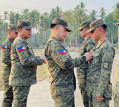 ZAMBOANGA. Brigadier General Alaric Avelino Delos Santos, 1102nd Infantry Brigade commander (center), on Monday, April 20, leads the pinning of ranks ceremony, honoring the newly-promoted officer and seven enlisted personnel of the brigade in Camp AKA that houses the brigade’s headquarters in Bual village, Luuk, Sulu.