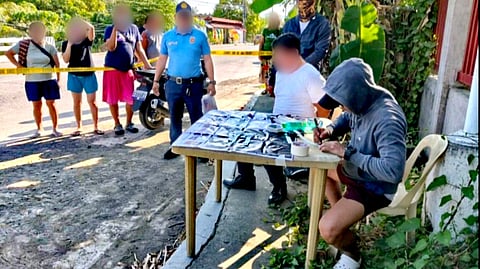 ILOILO. Operatives of the San Joaquin Municipal Police Station present a security guard arrested during a buy-bust operation in Barangay Siwaragan, San Joaquin, Iloilo on April 21, 2026, where about 55 grams of suspected shabu worth P374,000, marked money, and a motorcycle were seized.