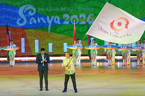 PH TAKES THE FLAG. Philippine Olympic Committee President Abraham “Bambol” Tolentino raises the Olympic Council of Asia flag after receiving it from OCA President Sheikh Joaan bin Hamad Al Thani during the closing ceremony of the 6th Asian Beach Games in Sanya, China, on Thursday, signaling the Philippines’ hosting of the next edition in Cebu in 2028.