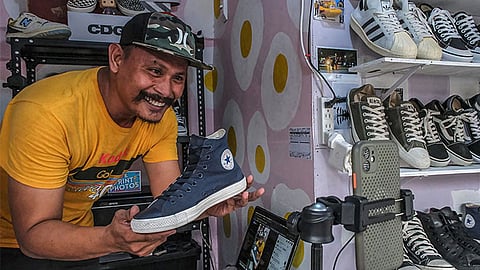 ONLINE SELLING. An entrepreneur showcases sneakers during a live online selling session, reflecting the growing role of e-commerce and digital platforms in helping small businesses reach more customers amid changing consumer trends. / File photo