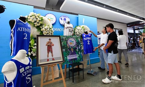 SOMBER HOMECOMING. Basketball jerseys and a framed portrait of Rene Clert “Bobet” Baterbonia in his team uniform are displayed at the Ateneo de Davao Senior High School–Bangkal Campus as supporters gather at Christ the King Chapel to pay their final respects on Friday evening, June 12, 2026. Baterbonia, a former core player of the Ateneo de Davao University (AdDU) Blue Knights, was named Most Valuable Player when the Davao Eagles secured their first-ever secondary boys’ basketball gold medal at the 2025 Palarong Pambansa. The 18-year-old athlete tragically died from drowning on June 8, 2026, during an off-campus team-building activity in Dipaculao, Aurora. He was a newly recruited rookie for the Ateneo de Manila University (AdMU) Blue Eagles men’s basketball team. His teammate, 21-year-old Nigerian student-athlete Chukwuemeka Divine Adili, also died in the incident after both were swept away by a strong rip current.