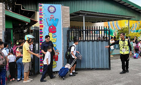 HEIGHTENED ALERT. A security personnel monitors arriving students and parents at the entrance gate of Kapitan Tomas Monteverde Sr. Central Elementary School SPED Center in Davao City. Following the unprecedented June 22 school shooting at San Jose National High School in Tacloban City that left three students dead and 20 others injured, the Department of Education (DepEd) and police authorities have ordered stricter implementation of campus entry and security screening protocols nationwide.