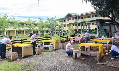 Employees of FDC Misamis volunteer to repaint various areas of Balacanas Elementary School as part of Brigada Eskwela 2026.