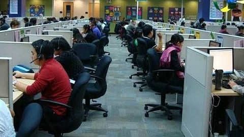 BPO office workers at their desks in a Cebu outsourcing center during a busy shift.