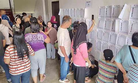 MOCK POLLS. Voters search for their names on the voter list posted outside a polling precinct in Cotabato City during the mock elections for the Bangsamoro Parliamentary Elections on Saturday, June 27, 2026. At least 500 voters participated in the mock elections held in several areas of the region.