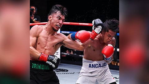 TRADING BLOWS. Omar Trinidad (left) lands a stiff left to the head of Jerwin Ancajas in this bit of action. / ZUFFA BOXING