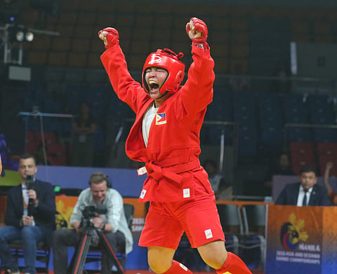 SUCCESSFUL TITLE DEFENSE. Aislinn Agnes Yap celebrates after successfully defending her women's -80-kilogram combat sambo title at the 11th Asia-Oceania Sambo Championships at Ninoy Aquino Stadium yesterday.
