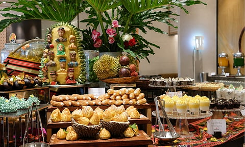 A vibrant showcase of Kadayawan Feast at Madayaw Café, featuring an abundant spread of local-inspired dishes, fresh Davao fruits, and specially crafted desserts highlighting beloved flavors such as durian and mangosteen.