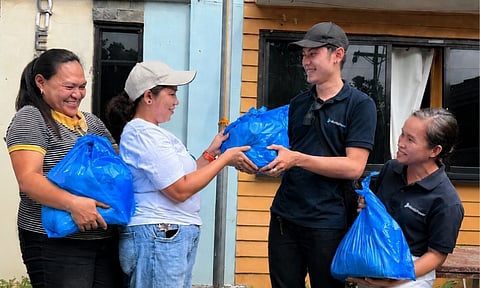 Representatives of Aboitiz Renewables, Inc. turn over relief food packs to officials of Barangay Catalunan Pequeño for distribution to families affected by the recent flooding.