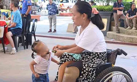 A local resident utilizing a wheelchair interacts with a young child during a community outreach and social services program organized by the City Social Welfare and Development Office (CSWDO). The local government agency continues to roll out inclusive welfare assistance, medical support, and community-building initiatives to aid persons with disabilities (PWDs) and marginalized families across the city.