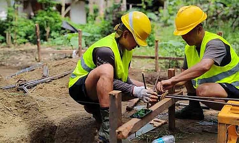 Personnel from the Philippine Army's 10th Infantry "Agila" Division assemble steel reinforcement rebars for temporary housing units. The military construction teams are deployed as part of the "Bangon Glan" rehabilitation initiative, building transitional shelters for local families displaced by destructive earthquakes in the province.