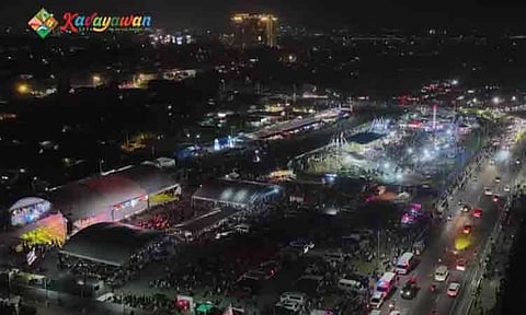 An aerial view shows crowds gathering at the Davao City Coastal Road during the evening festivities of the Kadayawan Festival. The annual celebration highlights the city's rich cultural heritage, indigenous tribes, and abundant harvests, drawing thousands of local and international visitors to various open-air event venues and coastal spectacles across the city.