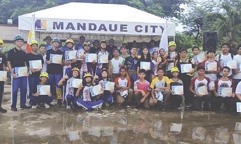RESILIENCE CHAMPIONS. The Labogon National High School team, representing the North District, poses with organizers after winning the Resilience Decathlon for Public High Schools 2026 at Pajara Park in Umapad, Mandaue City, on July 31. / Bantay Mandaue-CDRRMO