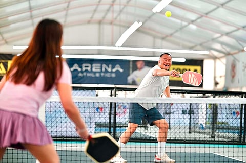 University of the Philippines Diliman alumnus Clevin Joy G. Conde returns a shot during a pickleball competition at The Arena Athletics along Carlos P. Garcia Highway (Diversion Road) in Davao City on Sunday.