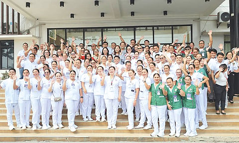 NEW REGULARS. About 80 Cebu Provincial Hospital employees in Bogo City gather after taking their oaths as regular, promoted and appointed employees of the Provincial Government, part of efforts to strengthen the province’s health care workforce. /