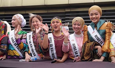 Cultural ambassadors representing the indigenous and ethnolinguistic tribes of Davao City wave to the crowd during the annual Kadayawan Festival. Wearing vibrant traditional attire and sashes, the candidates showcase their heritage in the "Hiyas sa Kadayawan" cultural pageant, a premier celebration highlighting the rich diversity, traditions, and unity of the city's 11 recognized tribes.