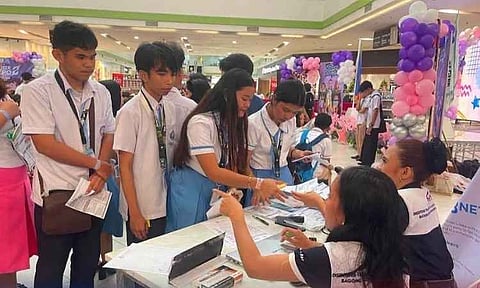 Students register at a Department of Labor and Employment (DOLE) booth during a public career expo held inside a local mall. Staff members assist the applicants with document submissions and inquiries, as the government agency conducts outreach and employment facilitation services for youth entering the workforce.