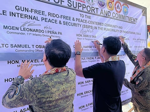 ZAMBOANGA. Major General Leonardo Peña, 11th Infantry Division commander (left) and Brigadier General Emmanuel Cabasan, 1103rd Infantry Brigade commander (right), sign the pledge of commitment Wednesday, September 9, during the recognizing the declaration of Pangutaran as a Gun-Free, Rido-Free and Peace-Centered Community, and the Status of State of Stable Internal Peace and Security.