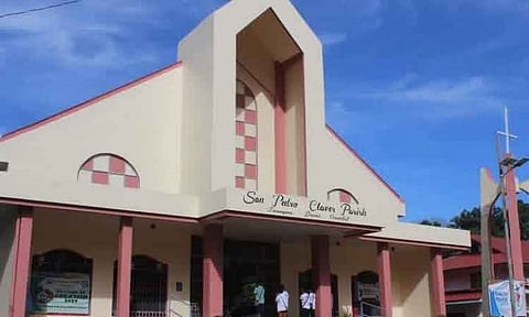 A view of the San Pedro Claver Parish church facade under a clear blue sky in Tarragona, Davao Oriental.