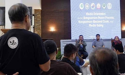 An attendee stands to ask a question during the "Media Orientation on the Bangsamoro Peace Process, Bangsamoro Electoral Code, and Media Safety" in the Philippines on August 19, 2026. Spearheaded by the Office of the Presidential Adviser on Peace, Reconciliation and Unity (OPAPRU) alongside the Presidential Task Force on Media Security (PTFoMS), the three-day briefing equips journalists with critical context on election-related protocols and security frameworks ahead of regional parliamentary elections.