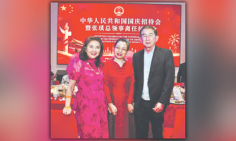 PROC NATIONAL DAY. Consul General of the People’s Republic of China Zhang Zhen, flanked by Secretary and Mrs. Philip Lo of the Office of the Presidential Assistant for the Visayas, during the celebration of the PROC National Day and farewell dinner in her honor.