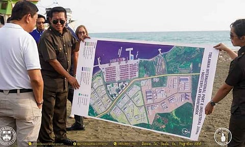 PORT PLANS. Officials inspect a proposed layout for the Tiblawan International Port and industrial zone in Governor Generoso, Davao Oriental, during a site visit. The proposed port is being studied as a potential gateway for trade, tourism and investment, including stronger connectivity with the BIMP-EAGA subregion.