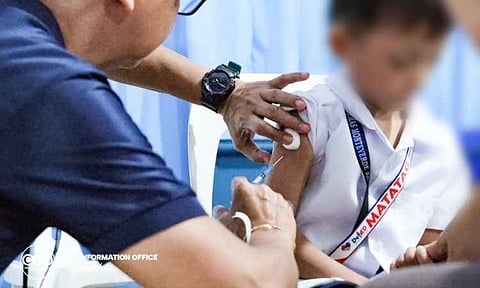 A healthcare worker administers a routine vaccine to a student at the Kapitan Tomas Monteverde Senior Central Elementary School during the ceremonial kickoff of a city-wide school-based immunization program. The Department of Education (DepEd) initiative aims to provide essential health protection to public school students across the region.