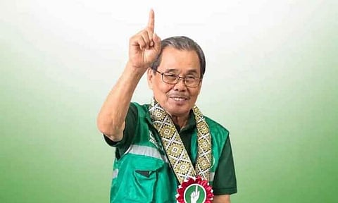 Bangsamoro Autonomous Region in Muslim Mindanao (BARMM) Chief Minister Ahod "Al Haj Murad" Ebrahim raises his index finger while campaigning for the United Bangsamoro Justice Party (UBJP) ahead of the upcoming regional elections. Ebrahim, who also serves as the chairman of the Moro Islamic Liberation Front (MILF), is wearing the party's signature green vest and a traditional sash adorned with a UBJP medal depicting the party's hand symbol.