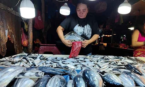 RISING MARKET PRICES. A vendor packs fresh seafood at Bankerohan Public Market during the morning rush in Davao City. The scene comes as the Philippines' inflation rate climbed to 7.2 percent in April 2026, the highest in three years, driven by rising food, fuel, and transport costs.