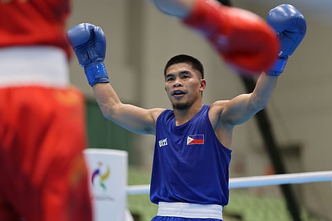 ON TO THE SEMIS. A Filipino boxer raises his gloves after his bout at the Aichi-Nagoya 2026 Asian Games in Japan. The Philippines advanced to the men’s 55-kilogram semifinals after a split-decision victory.