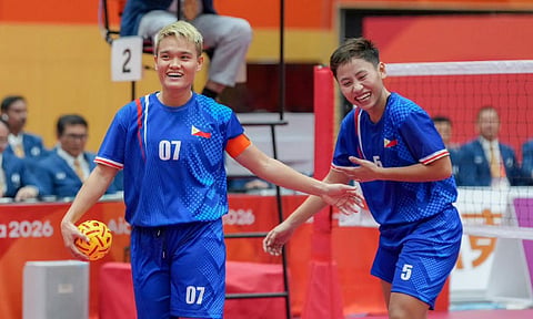 SILVER SMILES. Cebuana striker Jean Marie Sucalit (right) and Abegail Sinogbuhan flash smiles despite falling to Vietnam, 15-8, 15-5, in the women’s doubles finals of the 20th Asian Games at the Nagoya City Mizuho Park Gymnasium in Japan. The silver is the Philippines’ best finish in sepak takraw. / POC MEDIA POOL