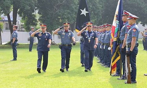 Police Brigadier General Benigno L. Guzman (front, center) and other high-ranking officers salute during a formal turnover of command ceremony at Camp Sgt. Quintin M. Merecido in Davao City. The event marked a official transition of leadership within the Police Regional Office 11 (PRO-11), witnessed by a formation of regional PNP personnel and flag bearers.