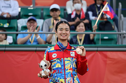 MEDAL GLOW. The Philippine women’s singles bronze medalist Alex Eala smiles as she holds her medal and Asian Games mascot after the medal ceremony in Nagoya, Japan.