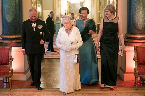 LONDON. Britain's Queen Elizabeth II, Prince Charles, Commonwealth Secretary-General Patricia Scotland and Prime Minister Theresa May walk in the Blue Drawing Room at Buckingham Palace as the Queen hosts a dinner during the Commonwealth Heads of Government Meeting, in London, Thursday April 19, 2018. (AP)