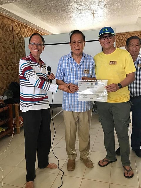 ILOILO. Environmental advocate Atty. Antonio Oposa gives Iloilo Governor Arthur Defensor Sr. and Provincial Administrator Raul Banias the Certificate of the Highest Recognition given by the United Nations Environmental Programme and the Institute of Governance and Sustainable Development (IGSD) based in Washington DC for the province's commitment to protect and preserve the Visayan Sea during an Earth Day celebration in Bantayan Island, Cebu on Sunday, April 22, 2018. At right is Negros Occidental Governor Alfredo MaraƱon. (Contributed Photo)