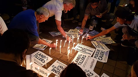 BACOLOD. Various groups hold a candlelighting activity in front of the Bishop's House in Bacolod City Wednesday afternoon. (Carla N. Cañet)