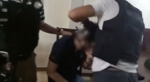 MANILA. Anti-kidnapping police officers remove the blindfold of the 19-year-old Letran student who was kidnapped by his fellow students. (Photo contributed by PNP-AKG)
