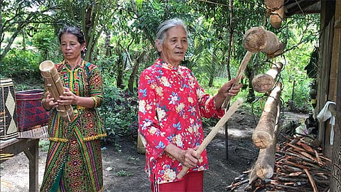 MAGUINDANAO. Teduray-Labangian civil society leader Conchita Quinlat (left) plays the Togo, a bamboo zither, while an elderly weaver plays the Kagol in barangay Kuya, South Upi, Maguindanao. (Photo by Stella A. Estremera)